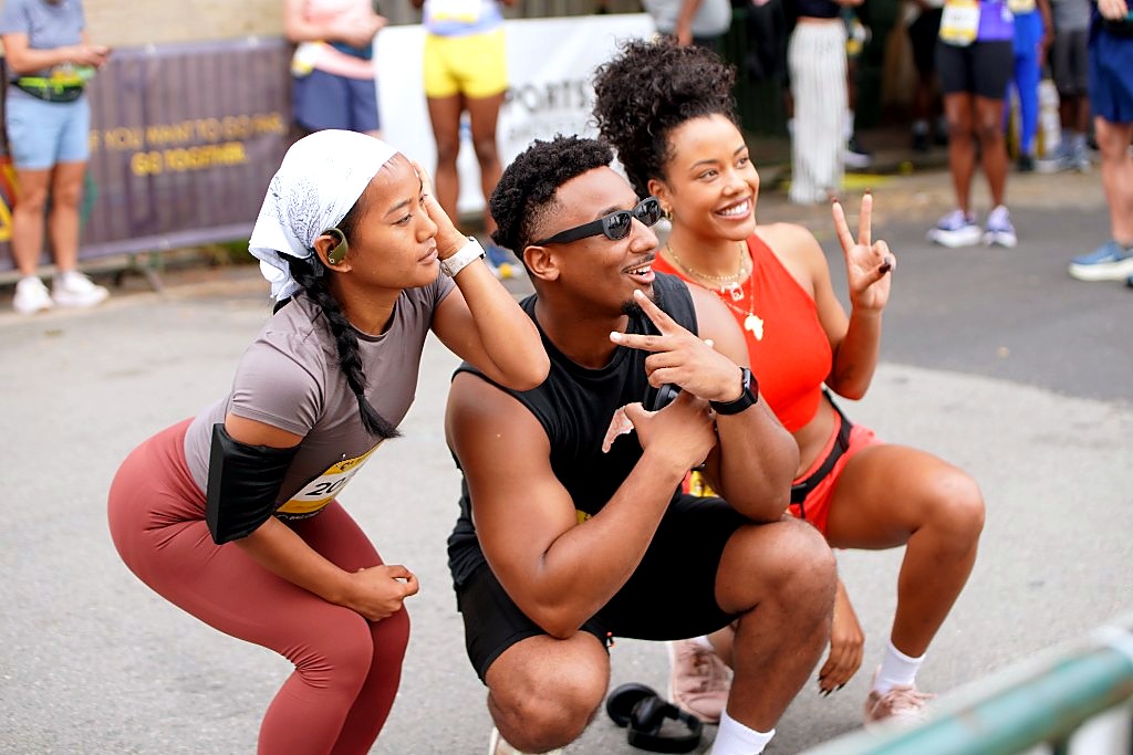 Three runners crouching for a playful photo along the Run Richmond 16.19 course